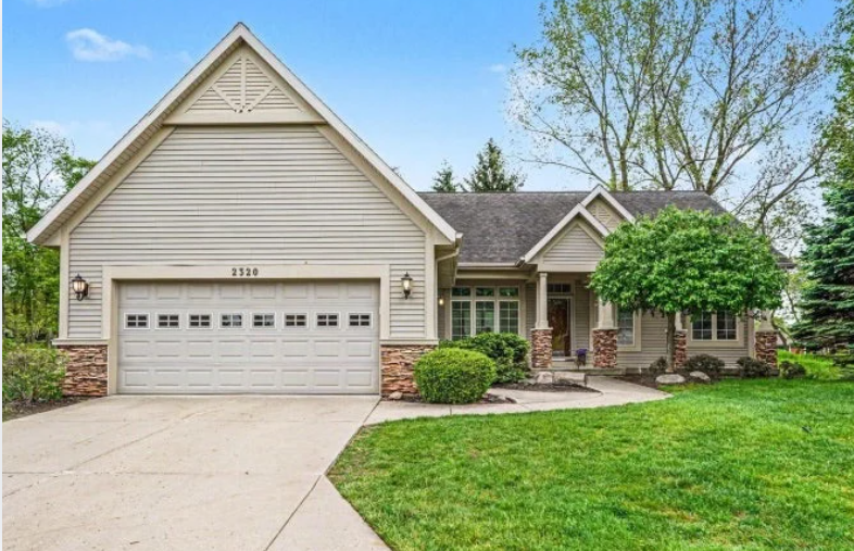 Stand-alone condo with a two-car garage and landscaped front yard